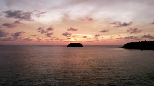 Orange Sunset with a View of the Island and Clouds