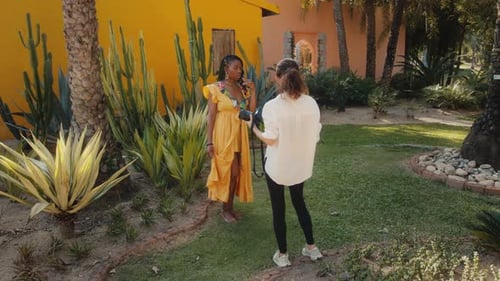 Woman in Yellow Dress Poses in Tropical Garden