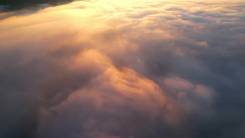 4K Aerial view flying in fog. clouds at sunset fog.
