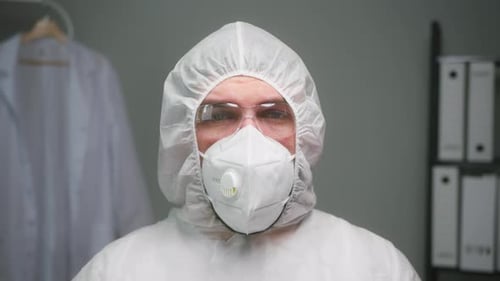 Overworked Doctor or Researcher Dressed in Protective Suit Ppe Mask in Laboratory in Hospital Man