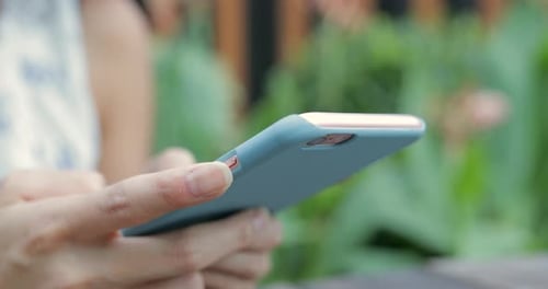 Hands Texting on Smartphone in Cafe