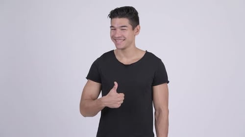 Young Man Gives an Enthusiastic Thumbs Up