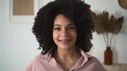 Smiling Woman with Braces in Indoor Setting
