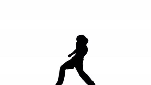 Un homme en silhouette danse avec désinvolture sur un fond blanc