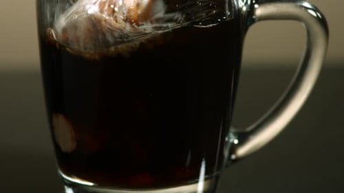 Cream Being Added to a Cup of Coffee