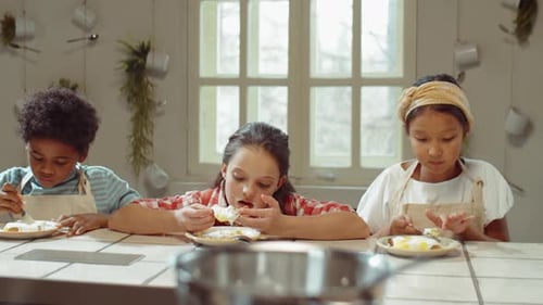 Multiethnic Kids Eating Sweet Waffles on Culinary Lesson