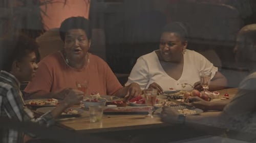 Family Dining and Talking Together Indoors at Night