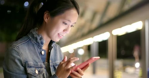 Woman Use of Mobile Phone in City at Night