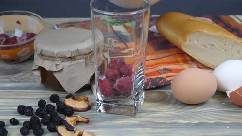 Milk Pouring into Raspberry Glass with Baking Ingredients