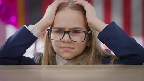 Closeup Sad Tired Teen Schoolgirl Holding Head in Hands Having Headache