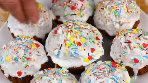 Decorating Cupcakes with Colorful Sprinkles and Icing