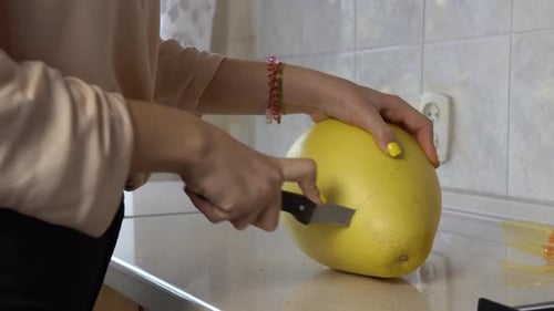 Cuts a Pomelo with a Knife Zoom