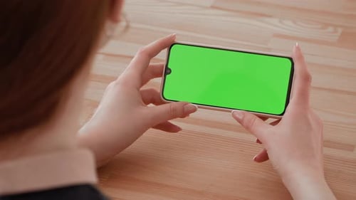 Handheld Camera Point of View of Woman Using Phone With Green Mockup Screen Chroma Key Surfing