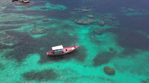 Boats Anchoring in Turquoise Shallow Water By the Edge of Coral Reef