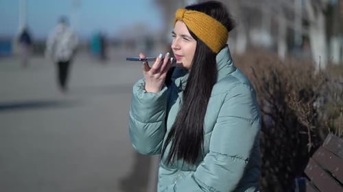 Woman Talking on Phone on City Park Bench