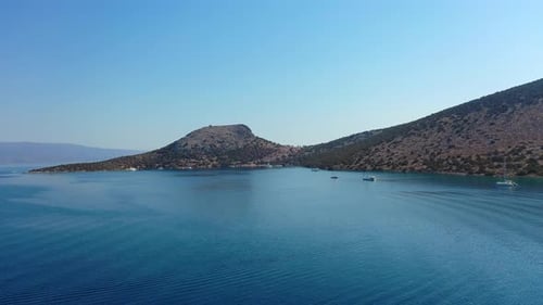 Catamaran and Sail Yachts Anchored at Bay on Deep Blue Sea Water on Sunrise