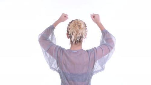 Rear View of Happy Blonde Woman with Fists Raised