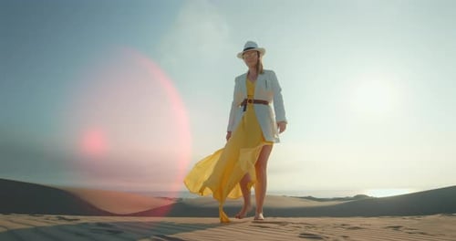 Stylish Lady Walking Barefoot on Sand Dune with Lense Flare