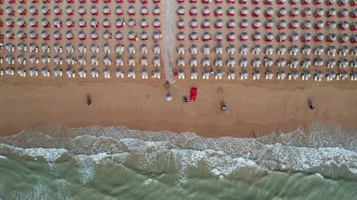 Aerial view of amazing beach with colorful umbrellas