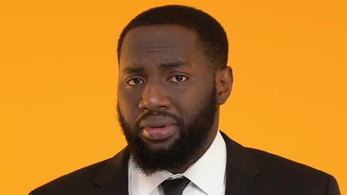 Man in Suit Close Up Looking Pained