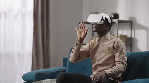 Man Using Virtual Reality Headset on Couch
