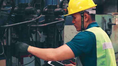 Smart Factory Worker Using Machine in Factory Workshop