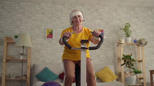 Senior Woman Exercising at Home on Exercise Bike