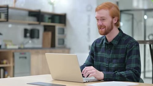 Cheerful Man Using Laptop for Video Conference at Home