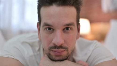Close Up of Serious Young Man Looking at Camera