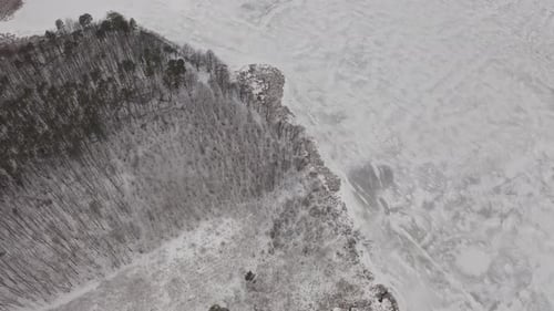 Aerial View Frozen Ice Of The River Near The Forest