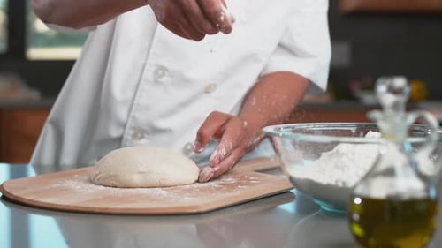 Chef sprinkles flour onto dough in super slow motion, shot with Phantom Flex 4K camera.