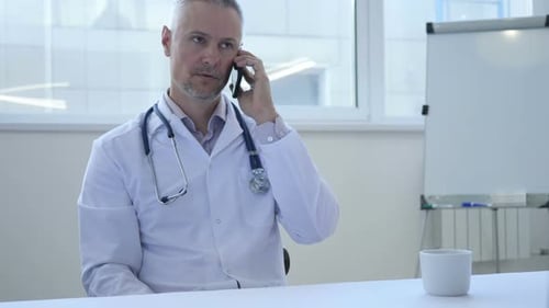 Doctor Talking on Phone in Bright Office Setting