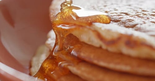 Golden Syrup Dripping Down Stack of Pancakes