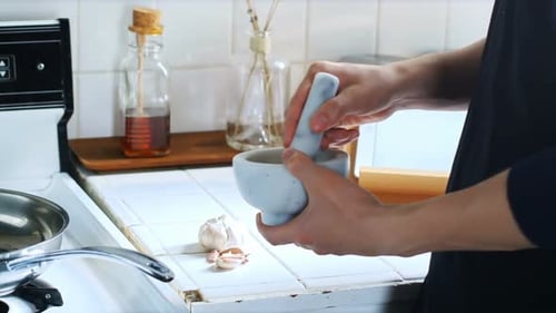 Man mixing ingredients in mortar and pestle 4k