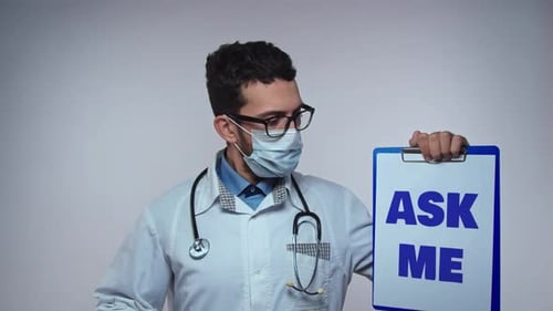 Young Adult Doctor Holding Ask Me Clipboard