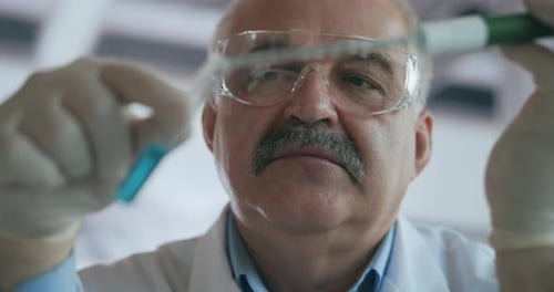 Scientist Examining Test Tube in Laboratory Setting
