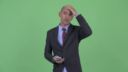 Frustrated Businessman Using Phone on Green Screen