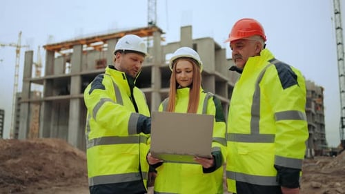 Foreman Architect and Civil Engineer are Checking Construction in Building Site Viewing Project in