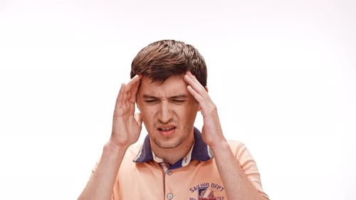 Man Rubbing Temples to Relieve Headache Pain