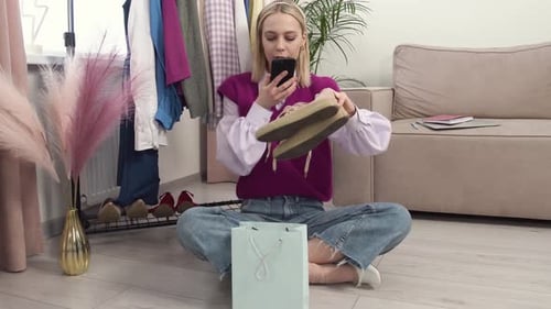 Blonde Woman Photographing Sneakers at Home