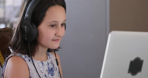 Girl Student Using Laptop Computer with Headphones