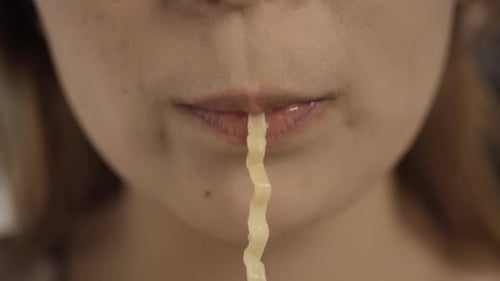Close-up of Woman Eating Noodles