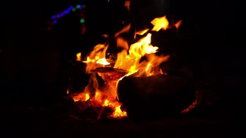 Burning Campfire with Glowing Flames at Night