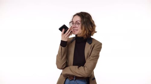 Young Woman Using Voice Command on Mobile Phone