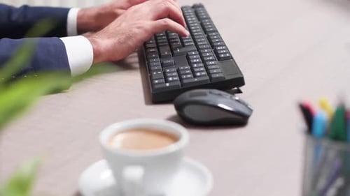Adult Typing at Computer on Desk in Office