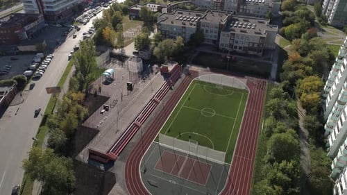 Stadium, basketball court and treadmills in the yard in the city. People go in for sports 10