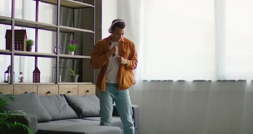 Young Adult Dancing and Singing at Home