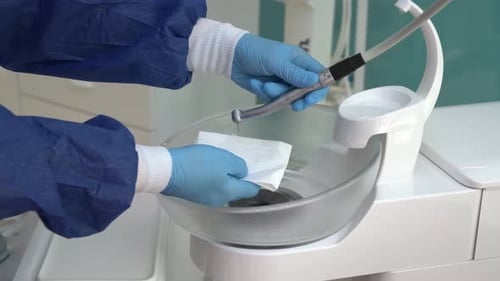 Dental Professional Testing a Drill in a Clinic