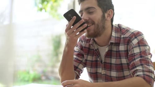 Young Adult Sending Text Messages on Cell Phone