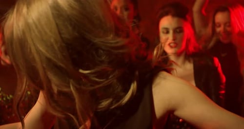 Young Woman Dancing with her Friends at a Nightclub